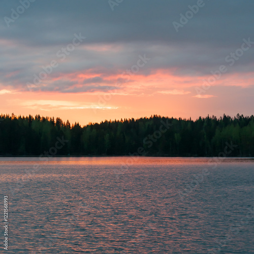 Early summer night by a lake in the forests of Finland photo