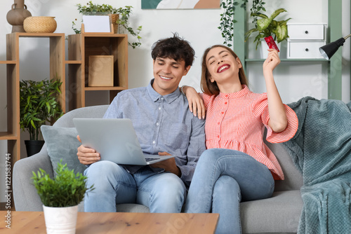 Young couple with laptop an...