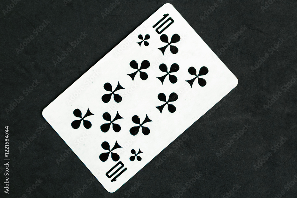 Ten of Clubs playing card, black background Ten of Clubs playing card, black background