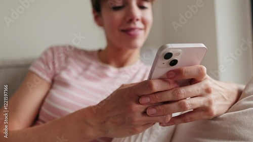 Happy woman using phone at home on sofa. Technology, social media, internet, communication