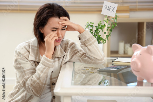 Sad young woman in debt at ...