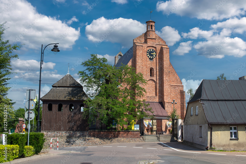Market square (Rynek w Pobiedziskach) and a catholic church (Parafia rzymskokatolicka Michała Archanioła) in Pobiedziska, Wielkopolskie, Poland.
