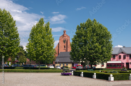 Market square (Rynek w Pobiedziskach) and a catholic church (Parafia rzymskokatolicka Michała Archanioła) in Pobiedziska, Wielkopolskie, Poland.  photo