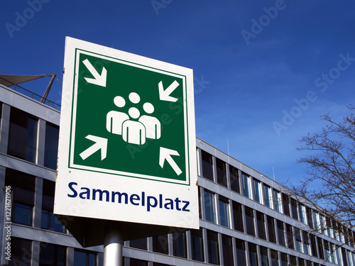 Sign “Sammelplatz” (assembly point) in front of an office building in Bonn, Germany. Concept: evacuation, drill, safety, emergency,