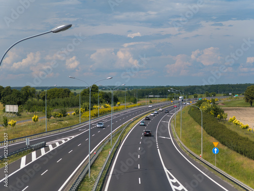 Obraz na płótnie Summer landscape view of cars moving on the freeway (highway) road between Poznan and Bydgoszcz (Droga ekspresowa S5) in Wielkopolska, Poland w salonie