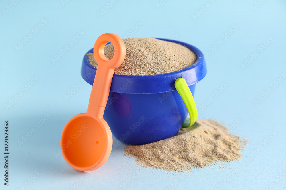 Beach toys and sand on light blue background Beach toys and sand on light blue background