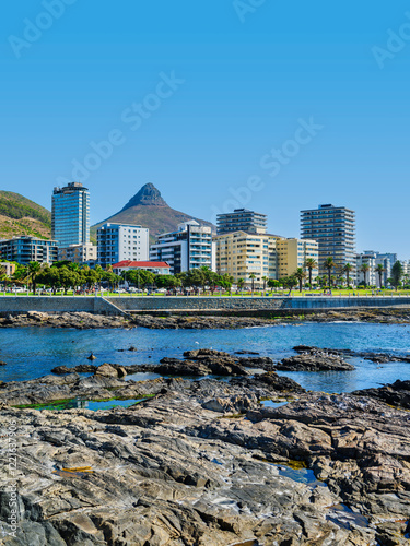 Obraz na płótnie Vertical shot of Sea Point view from the ocean with rocks and sparkling Atlantic Ocean, Cape Town, South Africa w salonie