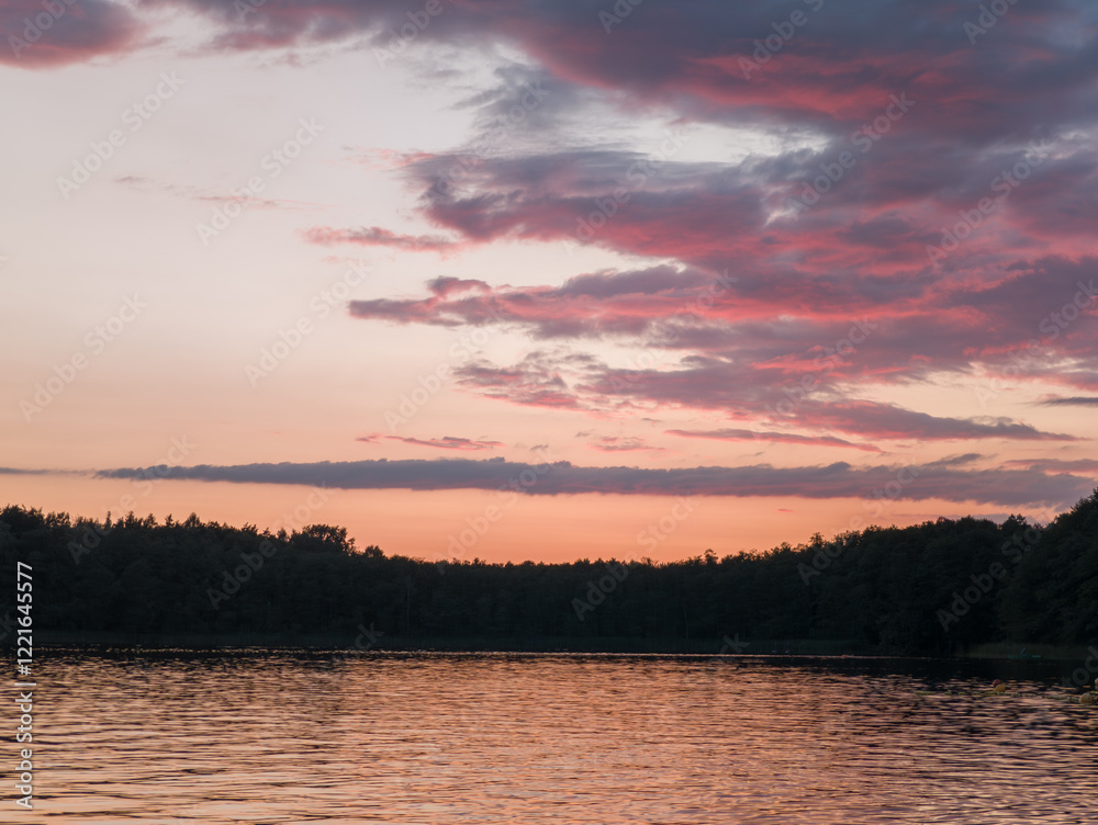 Scenic sunset sky, landscape view at Strzeszynek lake (Jezioro Strzeszyńskie), recreational beach area near Rusałka lake in Poznań, Poland.