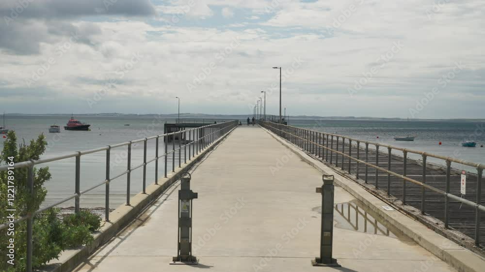 Clouds drift across the sky above a scenic pier, creating a peaceful and dynamic coastal atmosphere. Clouds drift across the sky above a scenic pier, creating a peaceful and dynamic coastal atmosphere.