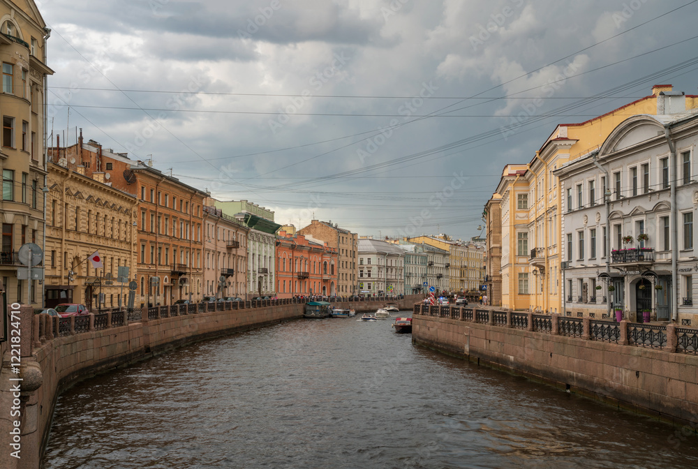 Fototapeta premium Moika River Embankment and Bolshoy Konyushenny Bridge on a cloudy spring morning, Saint Petersburg, Russia