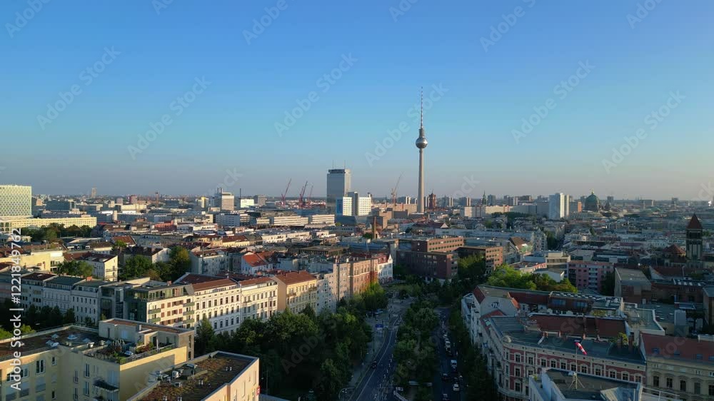 Berlin tv tower rising above rooftops and a construction site at senefelderplatz during sunset. Unique aerial view flight Berlin tv tower rising above rooftops and a construction site at senefelderplatz during sunset. Unique aerial view flight