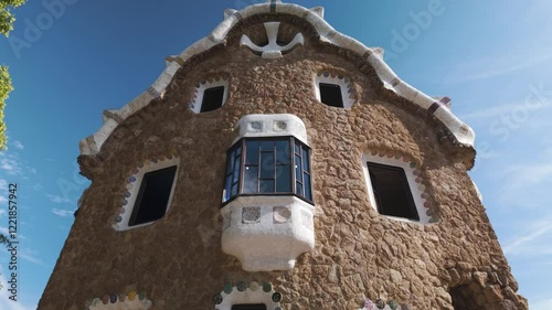 A close-up view of the Porter Lodge Pavilion showcasing its intricate architecture and organic design features in beautiful Park Güell, a famous landmark located in Barcelona, Spain.