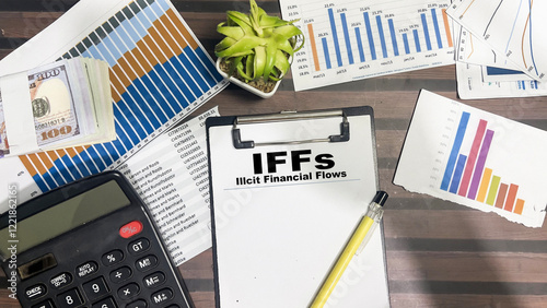 Tablou pe pânză Concept of IFFs - Illcit Financial Flows write on paperwork isolated on Wooden Table
