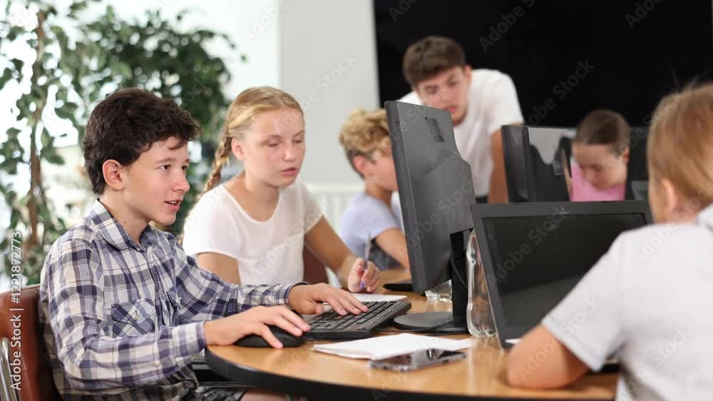 Computer science lesson in a school computer class - a girl and a boy solve problems on the computer together. High quality 4k footage Computer science lesson in a school computer class - a girl and a boy solve problems on the computer together. High quality 4k footage