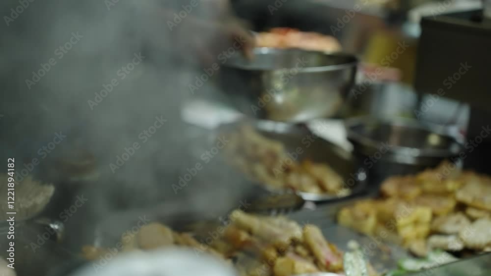 Close-up of preparing asian street food in China at a bustling street market, using a ladle to serve steaming hot dishes into a metal bowl, surrounded by various ingredients and trays of food Close-up of preparing asian street food in China at a bustling street market, using a ladle to serve steaming hot dishes into a metal bowl, surrounded by various ingredients and trays of food