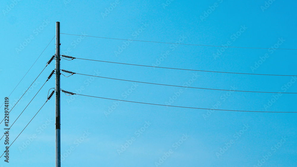 Minimalist Urban Lines – Power Pole Against Clear Sky, Perfect for Industrial Themes, Contemporary Art, or City Branding Projects. Minimalist Urban Lines – Power Pole Against Clear Sky, Perfect for Industrial Themes, Contemporary Art, or City Branding Projects.