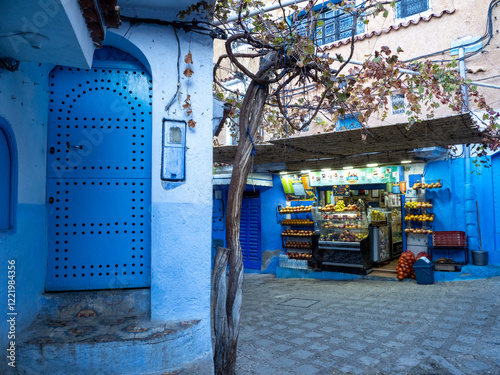 Chefchaouen,  the blue city in Morocco - Street scene with arch and fruit shop in the Medina