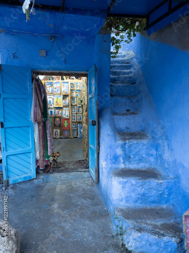 Chefchaouen,  the blue city in Morocco - open door into. a shop with steep stairs by the side
