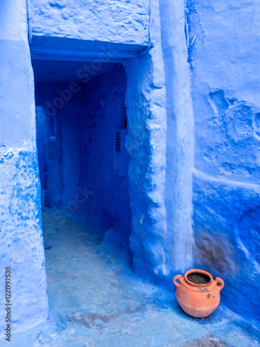 Chefchaouen,  the blue city in Morocco - blue doorway with contrasting terra cotta pot