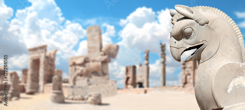 Horizontal banner with stone statue of mythical creature griffin and columns of Apadana Palace at the Persepolis, Iran. Topic of summer vacation, travel, trip abroad on vacation, cruises and tours photo