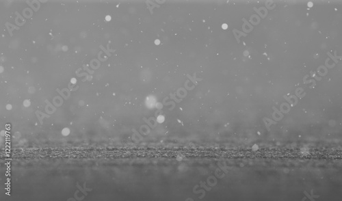 Black bokeh texture on black studio background. Use as montage for product display.
