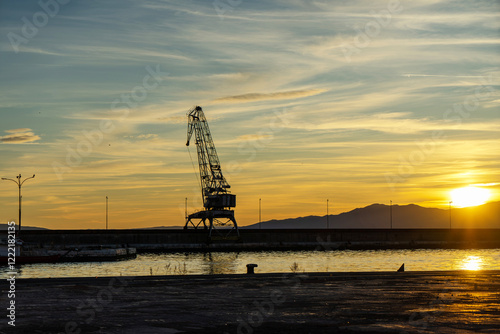 A large port crane photographed at sunset photo