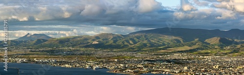 Obraz na płótnie Panoramic view of Hakodate City from the observation deck on top of Mt. Hakodate. In the evening, the city and mountains in the background are beautifully golden. w salonie
