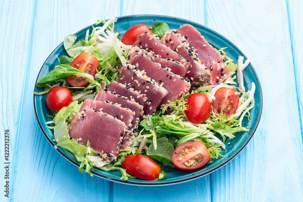 Salad with raw tuna , sesame and cherry tomatoes photography . Top view Salad with raw tuna , sesame and cherry tomatoes photography . Top view