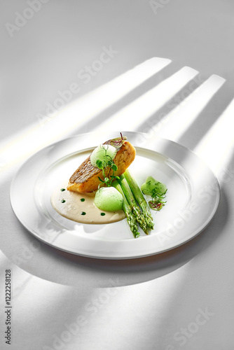 Obraz na płótnie A beautifully plated salmon fillet, seared to perfection and served with tender asparagus spears