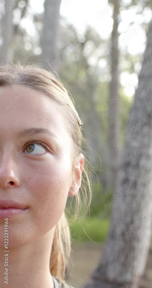 Vertical video: Close-up of woman hiking in forest, enjoying nature and fresh air Vertical video: Close-up of woman hiking in forest, enjoying nature and fresh air