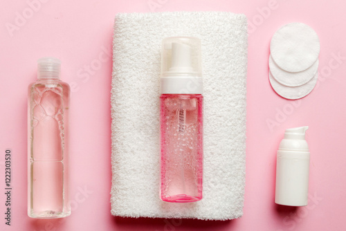 Micellar cleansing water and discs to remove cosmetics and cleanse the skin on colored background. Copy space top view