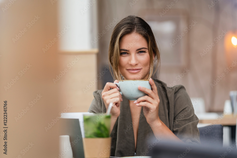Young businesswoman with coffee cup in a cafe Young businesswoman with coffee cup in a cafe