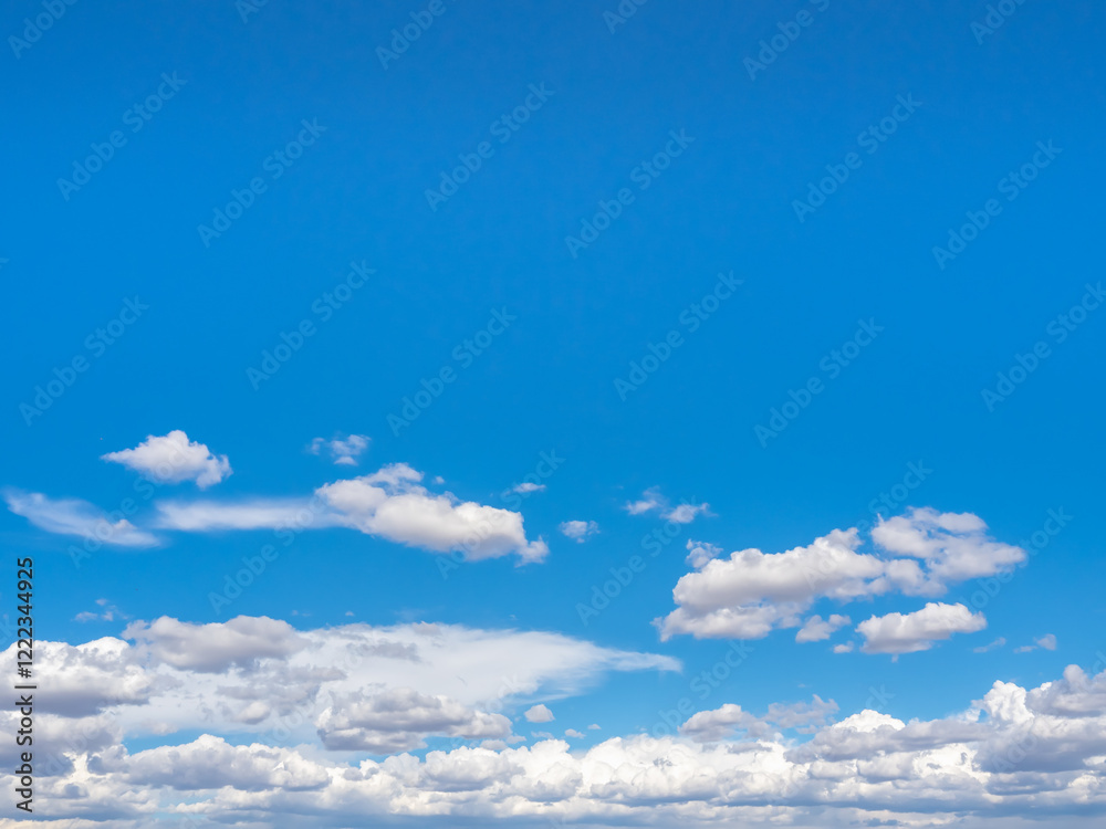 Abstract blue sky background scene with white fluffy cloud with space, horizontal style. Cloudy floating scattered and blowing with the nature wind on the horizon sky. Abstract blue sky background scene with white fluffy cloud with space, horizontal style. Cloudy floating scattered and blowing with the nature wind on the horizon sky.