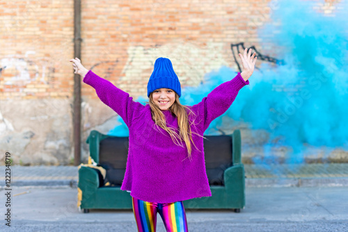 Young girl with sofa and turquoise color powder in the background photo