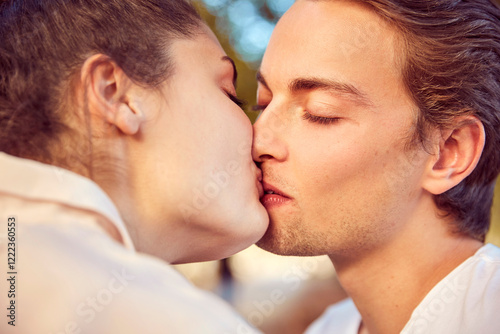 Young couple in love kissing outdoors photo