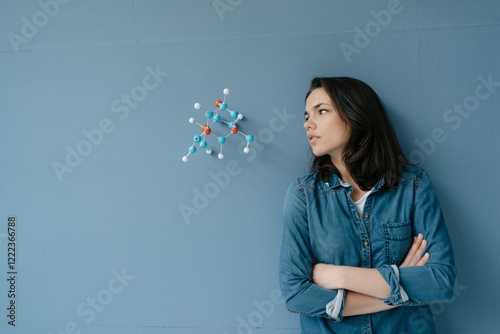 Female scientist studying molecule model, looking for solutions photo