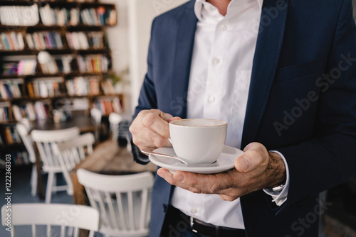 Close-up of businessman having a coffee in a cafe photo