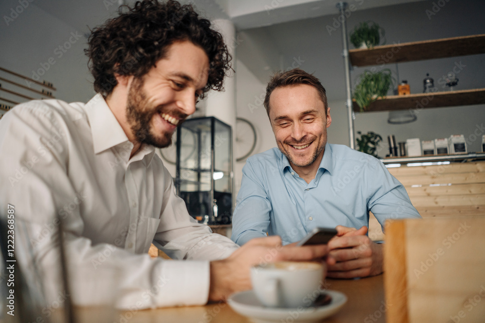 Two businessmen having a meeting in a coffee shop Two businessmen having a meeting in a coffee shop