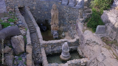 Fountain for Coins and Luck at Temple of Mercy, Haedong Yonggungsa, Busan, Korea photo