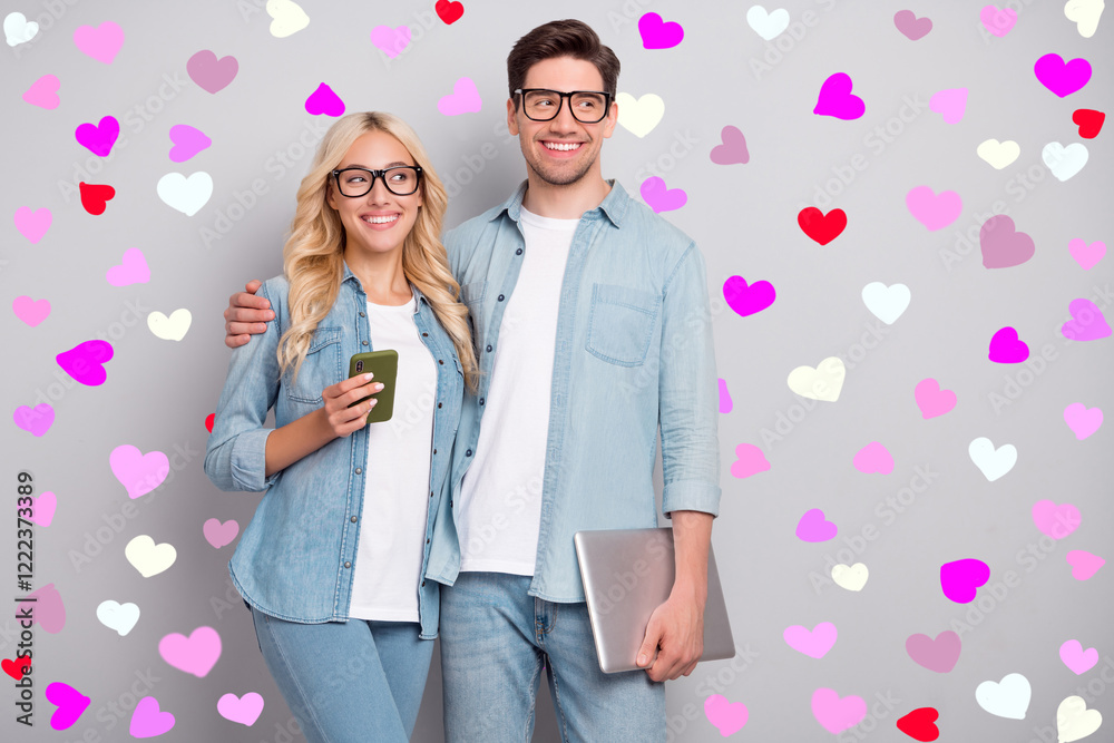 Photo of nice couple hold laptop telephone look wear jeans shirt isolated on grey color background Photo of nice couple hold laptop telephone look wear jeans shirt isolated on grey color background