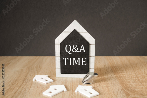 Obraz na płótnie Concept words 'Q and A time' on black blackboard. Beautiful wooden table, black background. A stack of coins. Business and Q and A time concept. w salonie