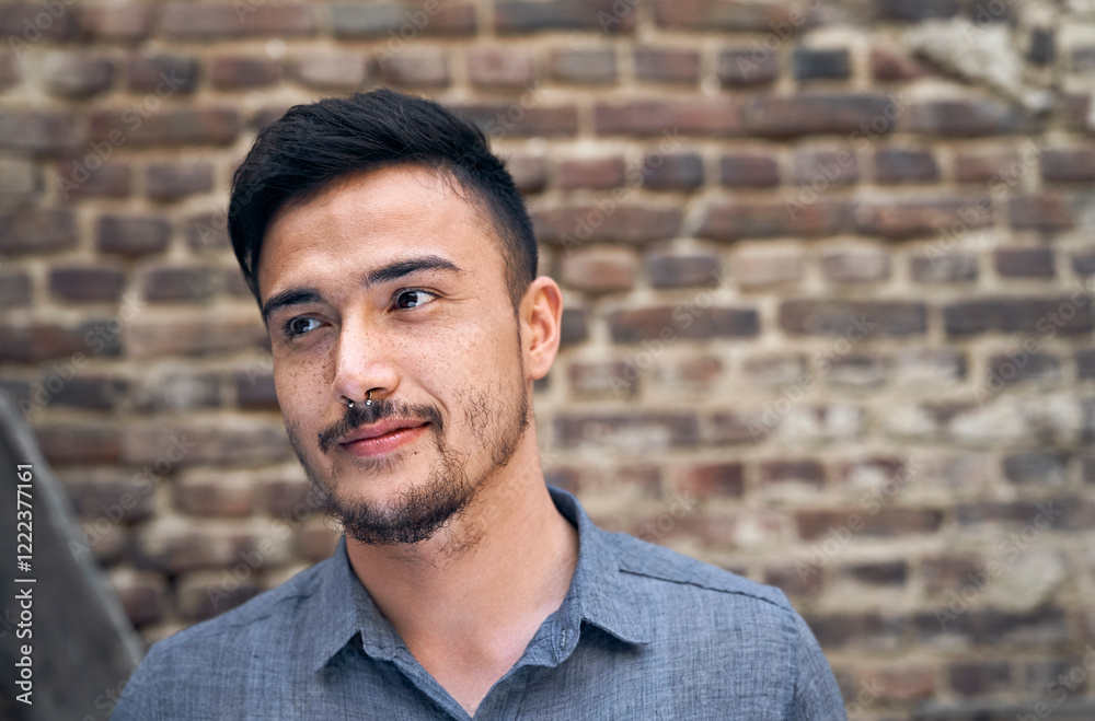 Portrait of a young man in front of a brick wall Portrait of a young man in front of a brick wall