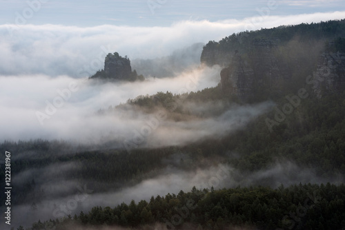 Germany, Saxony, Elbe Sandstone Mountains, view from Gleitmannshorn to sandstone rocks with fog at sunrise photo