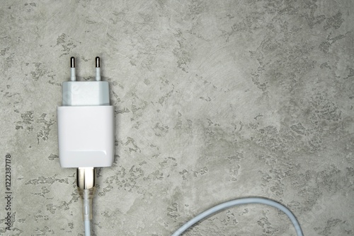 Power adapter with USB cable on gray. Charger for home electronics