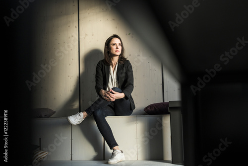 Businesswoman sitting in lounge area in office photo