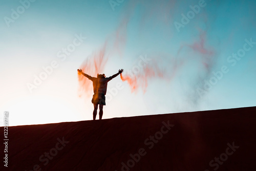 Sultanate Of Oman, Wahiba Sands, Mid adult man is playing with sand in the desert photo