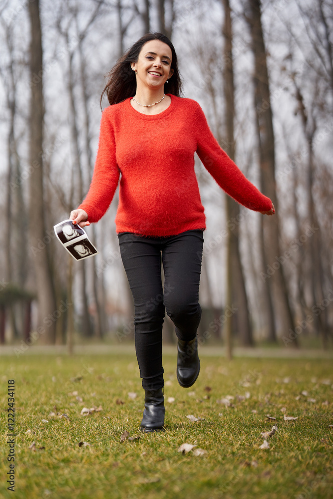 Pregnant woman running with ultrasound outdoors Pregnant woman running with ultrasound outdoors