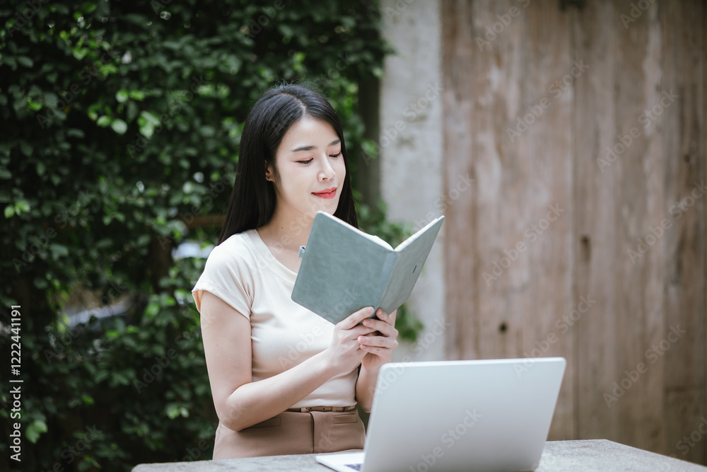 Obraz premium Confident Asian woman working on laptop outdoors. She embraces technology and freelancing, modern entrepreneurship, e-banking and urban success with determination and efficiency.