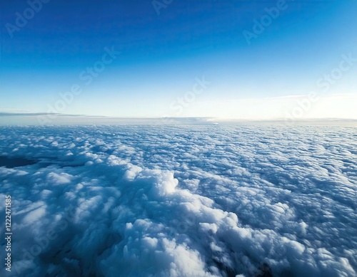 bright cloudy sky view from airplane. White clouds on blue sky background close up, cumulus clouds high in azure skies, beautiful aerial cloudscape view from above.