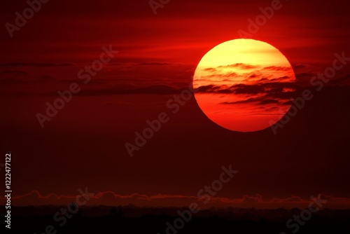 Witnessing the breathtaking sight of a red sun during scorching temperatures.